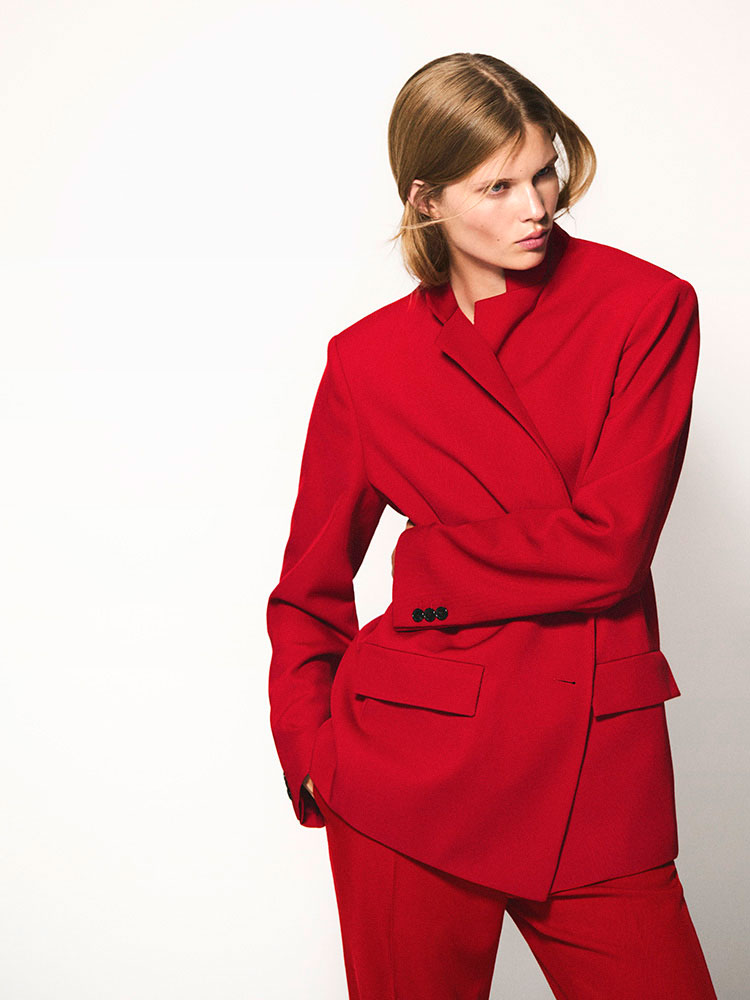 man wearing turtleneck standing on balcony